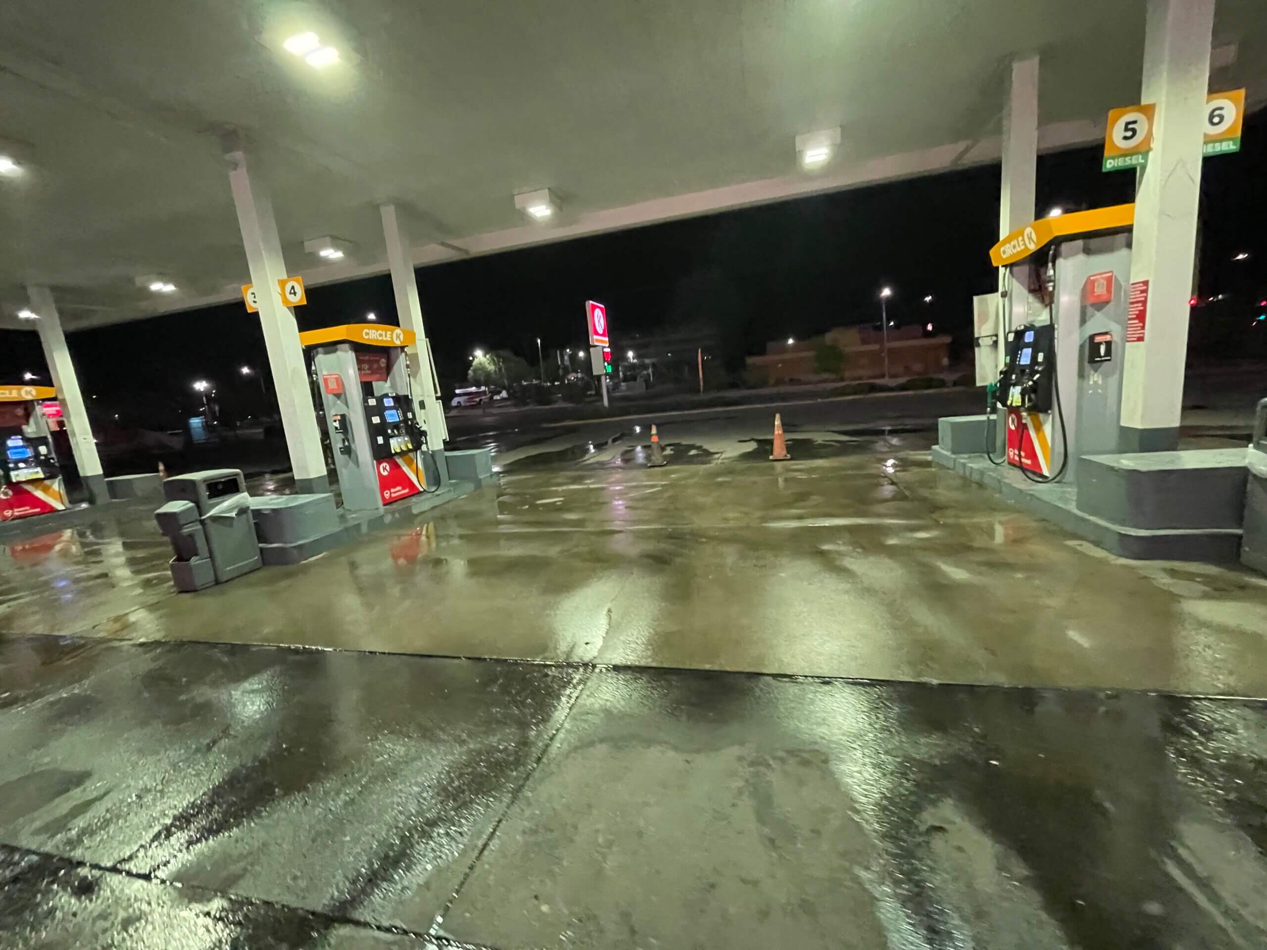 PowerWash Pro industrial pressure washing trailer performing deep gas station concrete degreasing.