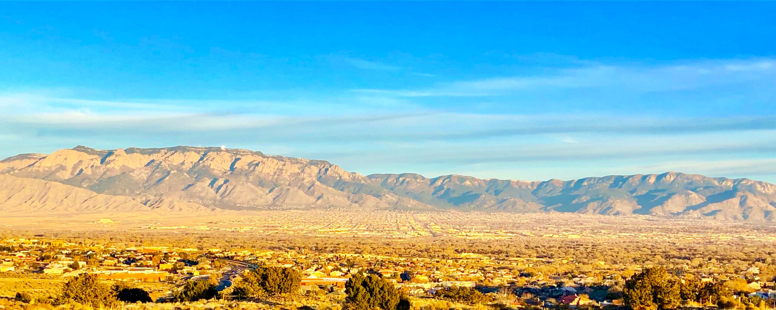 Albuquerque City Panoramic with beautiful Sandia Mountains and glistening Sandia Tram sparkling - Gianna Naveah sparkles a top the Sandia Peak