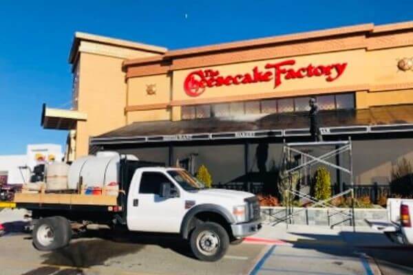 PowerWash Pro service truck performing exterior restaurant cleaning at The Cheesecake Factory.