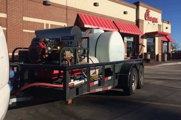 PowerWash Pro hot-water pressure washing trailer at a Chick-fil-A restaurant.