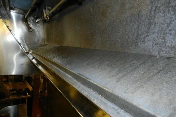 Restaurant kitchen hood interior restored to bare metal after professional exhaust system cleaning by PowerWash Pro.